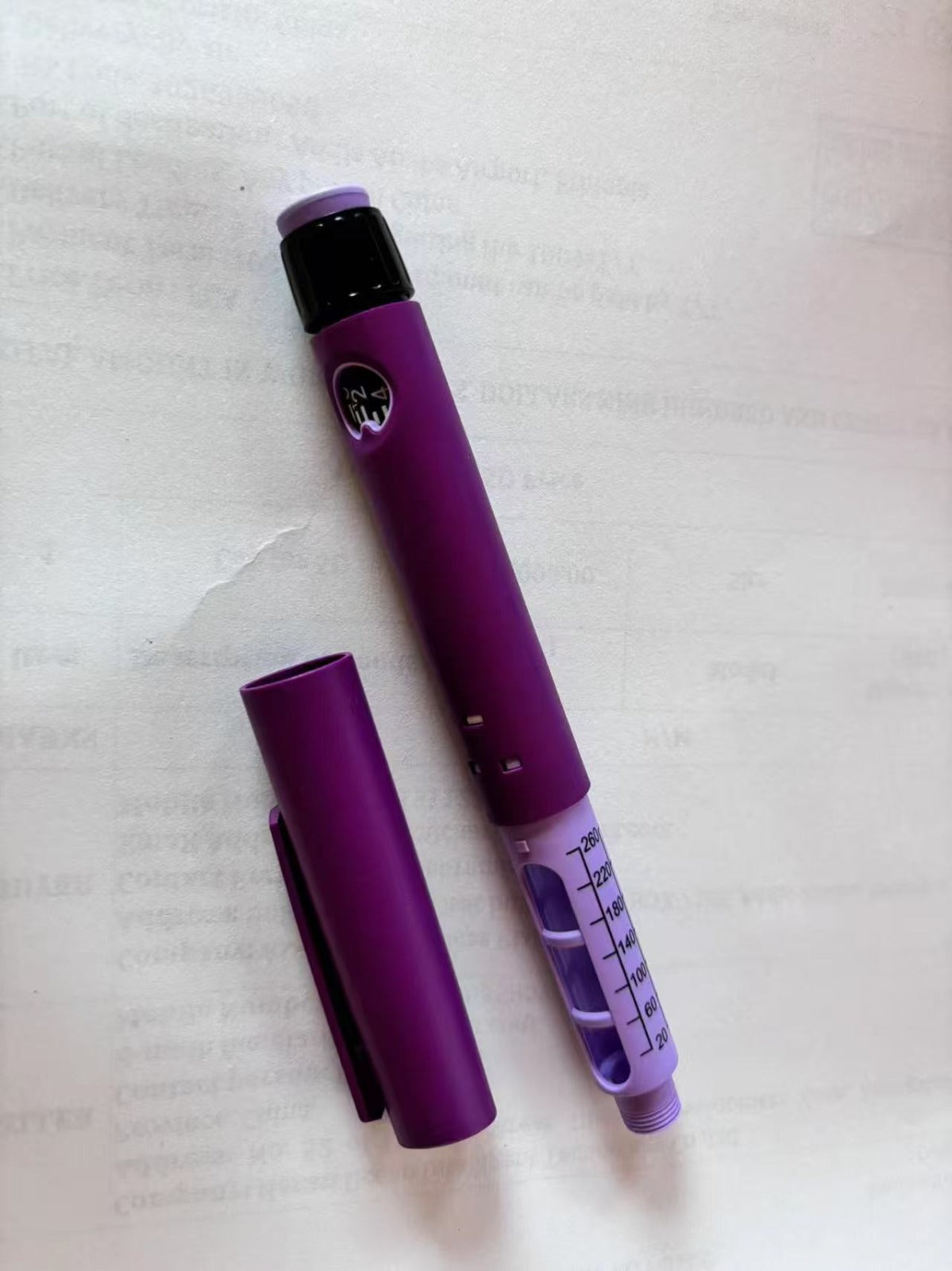 Disposable peptide pen: Purple auto-injector pen with dosage markings, ready for use.
